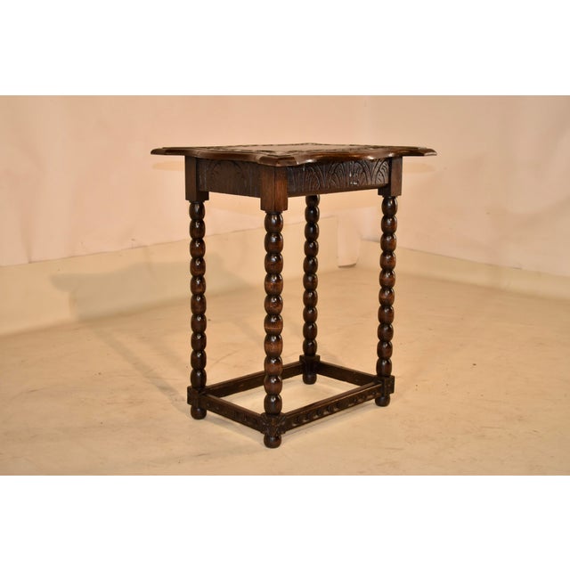 Late 19th century hand-carved oak side table from England. The top of this table is magnificent! The top is scalloped and...