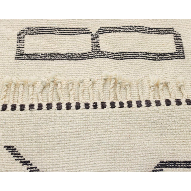 A warm welcome, woven in wool. This hand-knotted wool runner features a bold, oversized greeting rendered in clean...