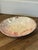 This Sascha Brastoff Surf Ballet bowl features a marbled pink and white design with 24K gold accents.