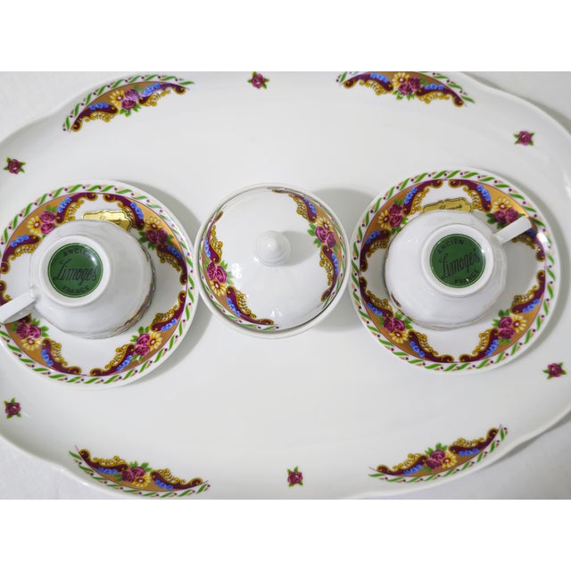 Vintage Limoges porcelain coffee set. The set consists of two cups and saucers, a sugar bowl with lid, and a matching oval...