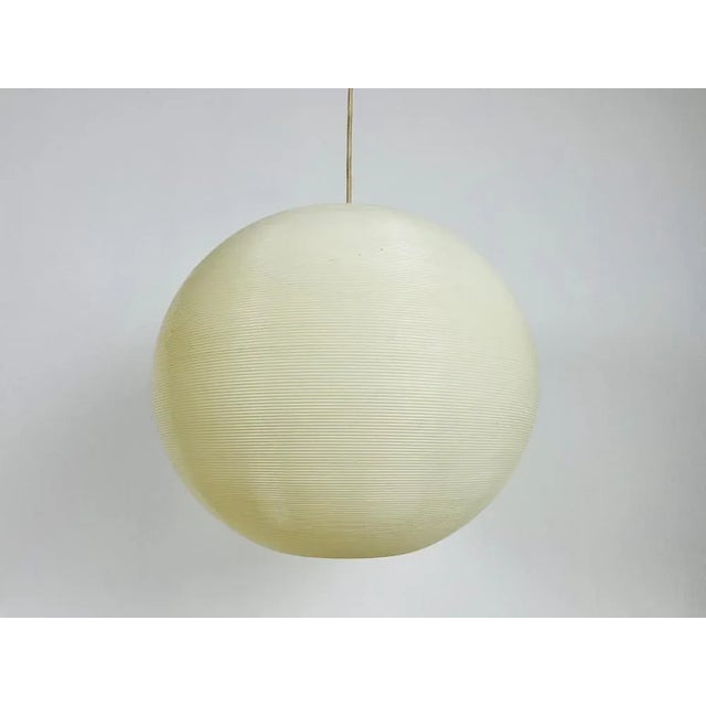 Mid-Century Modern Rotaflex ball pendant lamp made in the 1960s. The lamp shade is made of continuous plastic cords spun...