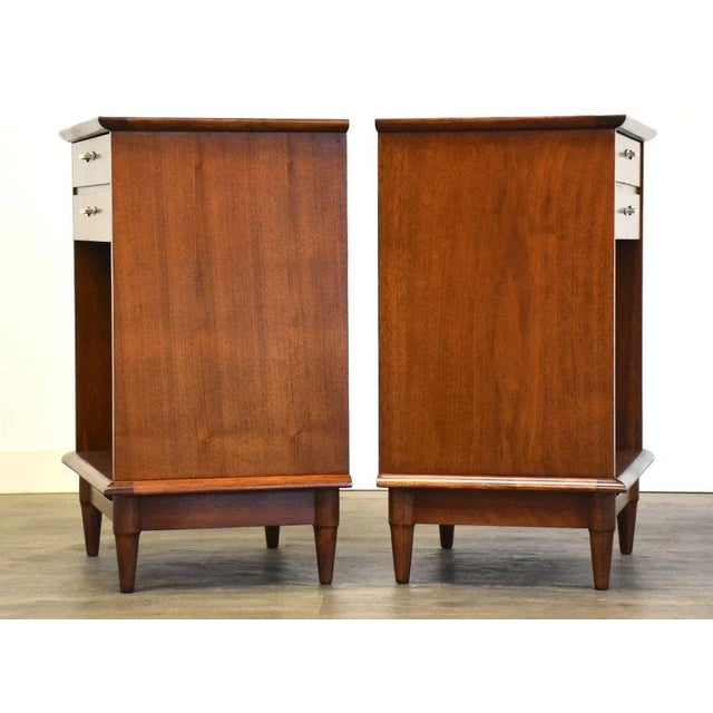 A pair of walnut mid century modern nightstands with chrome drawer pulls by Lane. Professionally refinished. 22” wide. 15”...