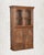 Four doors- two glass above, two solid below. A cabinet that knows exactly what it is. This antique Indian armoire in warm...