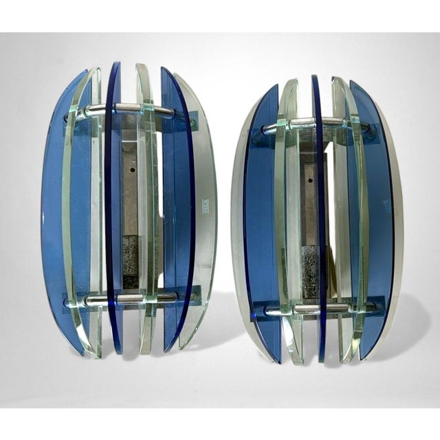 Elegant and streamlined pair of vintage Italian wall sconces in polished, nickel-plated brass. Each sconce features a...