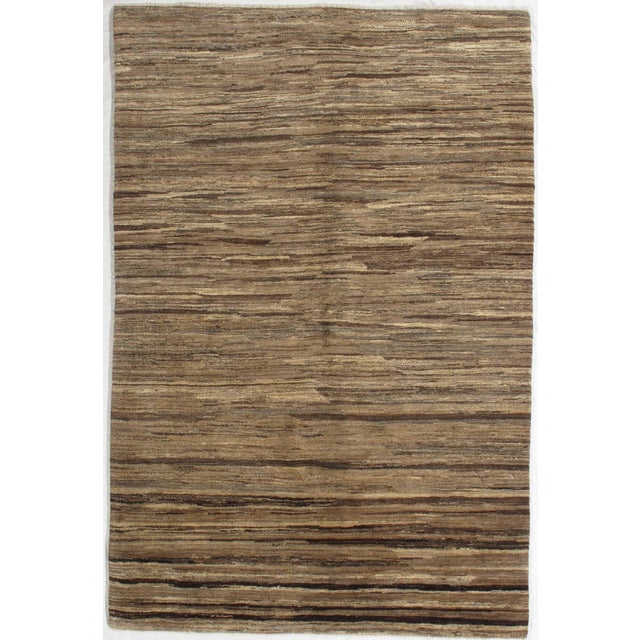 Vintage hand-knotted Gabbeh rug featuring a richly textured field with horizontal striations and natural tonal variation....