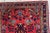 Handmade vintage Sarouk rug in traditional design. The rug is in red color. The rug is from the end of 20th century in...