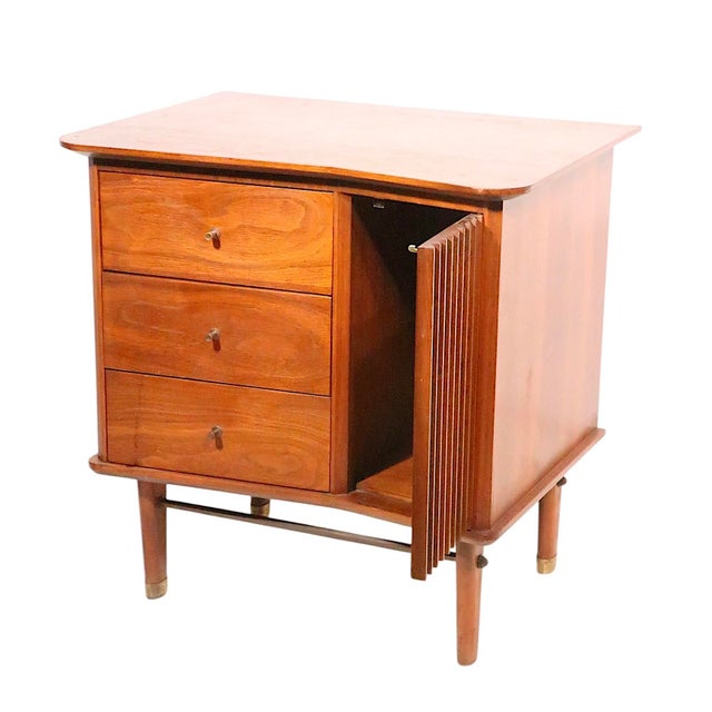 Well crafted mid century night stand made by the United Furniture Corporation circa 1950's. The night table features a...