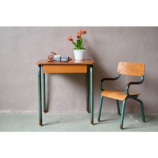 Charming and full of character, this children's desk and chair set tells the story of post-war French school furniture, in...
