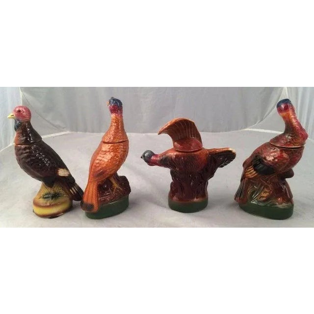 A set of eight vintage mini wild Turkey decanters featuring the popular and hard-to-find #3 flying and #8 fan-tail...