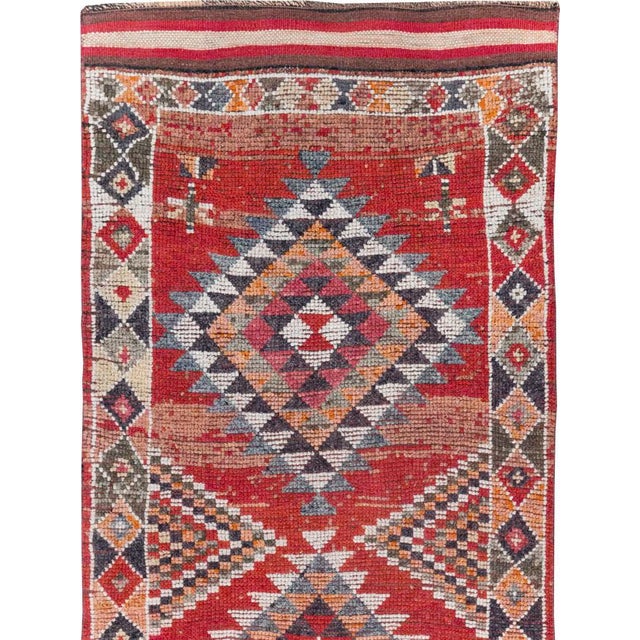 This mid-20th-century Turkish Anatolian tribal runner presents a bold sequence of four large diamond medallions arranged...