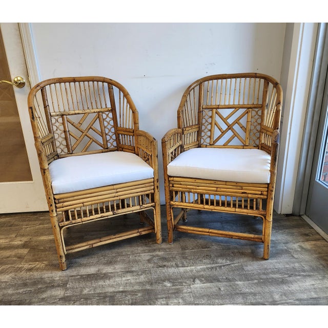 A pair of classic Brighton Pavilion style bamboo and cane armchairs with Chippendale style fretwork detailing. New...