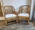 A pair of classic Brighton Pavilion style bamboo and cane armchairs with Chippendale style fretwork detailing. New...
