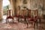 An exceptional set of eight solid wild black cherry dining chairs by the renowned Henkel Harris, produced during their...