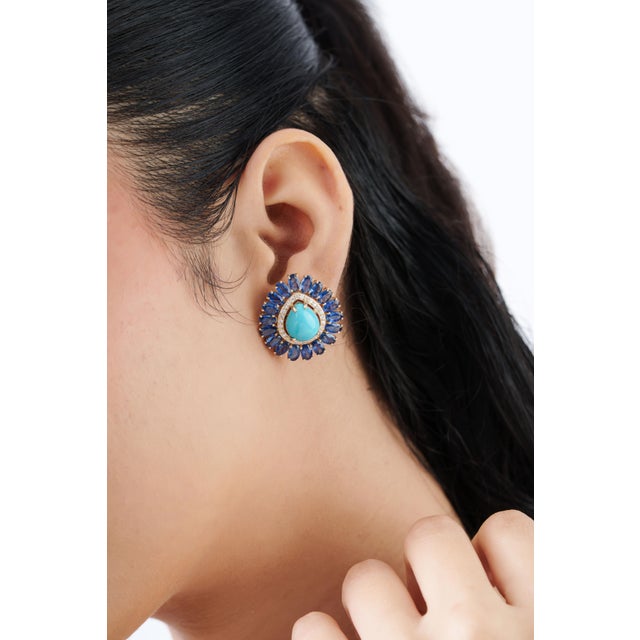 Add a luxurious pop of color to your jewelry collection with these stunning 14K yellow gold turquoise and sapphire halo...