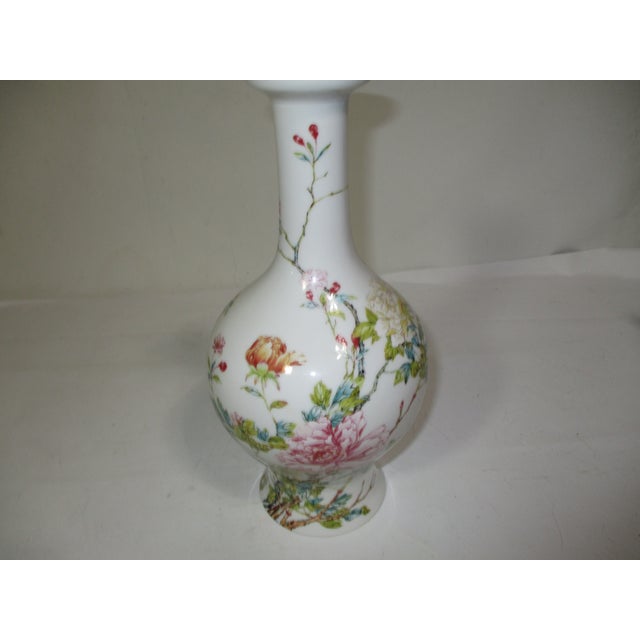 A vintage Lenox porcelain Japanese Chrysanthemum long neck vase. It is decorated with florals in colors of rose, yellow,...