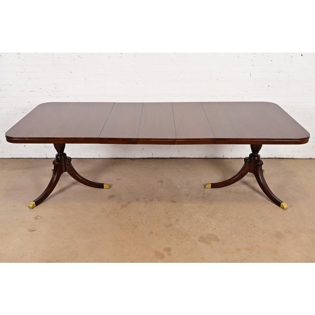 An exceptional Georgian or Regency style double pedestal extension dining table By Drexel USA, 1949 Gorgeous mahogany,...