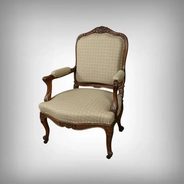 This Louis XV-style beechwood armchair embodies the elegance and refinement of mid-19th-century French furniture. Its...