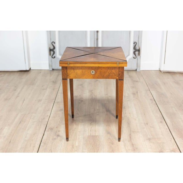 This 19th-century French game table is a masterful blend of form and function, showcasing the exquisite craftsmanship...