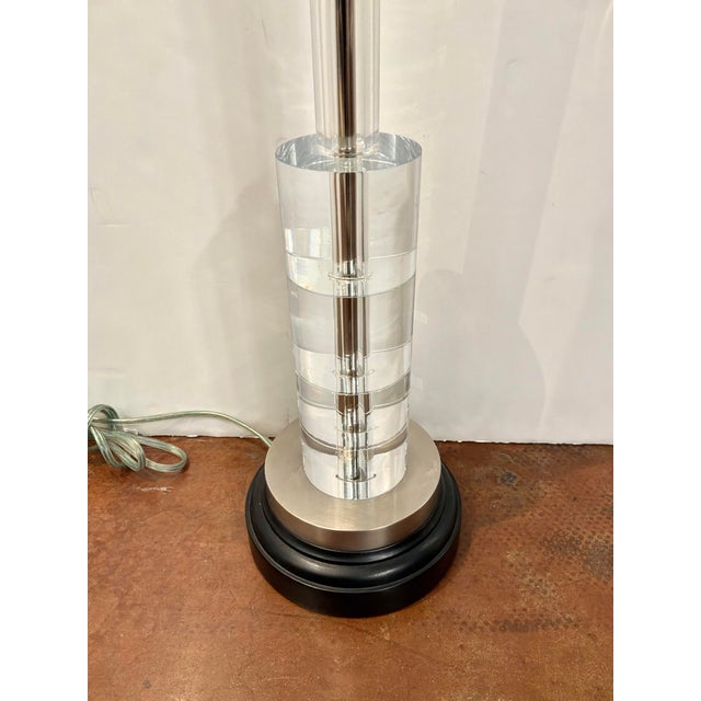 Stylish John Richard Lamp, glass cylinder body on black round base. Showroom floor sample.