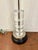 Stylish John Richard Lamp, glass cylinder body on black round base. Showroom floor sample.