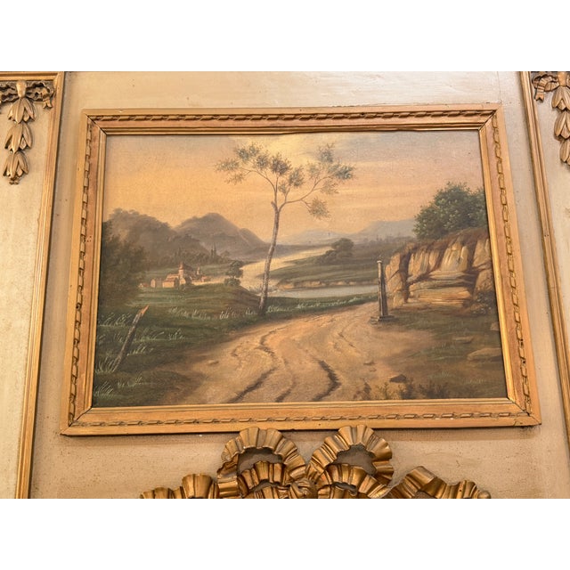 An exceptional and stately 19th-century French Louis XVI style trumeau mantel mirror. This striking architectural piece...