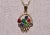 The Noack: Yellow Gold Flower Basket Pendant. The pendant features red, green, and blue enamel flowers atop a weaved...