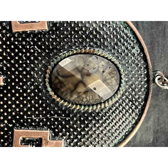 Pair of vintage Art Deco Revival earrings featuring stylized Egyptian motifs with large domed ovals, stepped geometric...