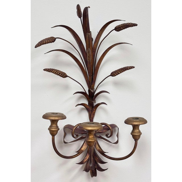 Vintage Italian style gilt metal sheaf of wheat wall sconce with three (3) carved wood arms to hold candlesticks. Each cup...