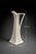A striking mid-century modern ceramic ewer vase with a tall architectural silhouette and elegant sculptural handle....
