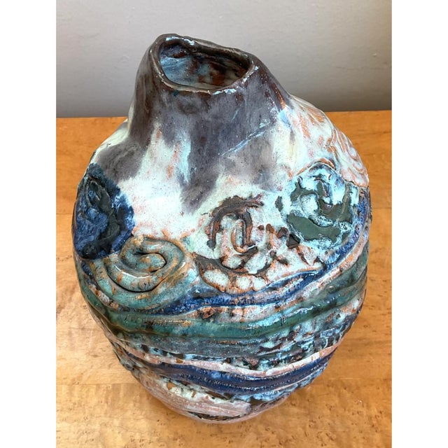 Hand-crafted in glazed ceramic, this vintage studio pottery vessel features a striking abstract silhouette defined by...