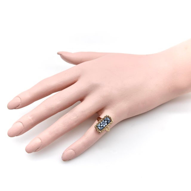 This Victorian 14k gold ring features a beautiful elongated panel carved from a black and white banded agate. The central...