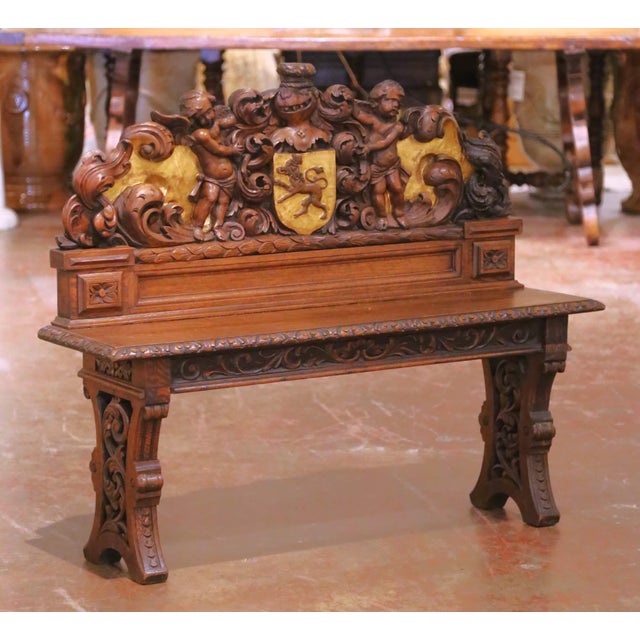 Crafted in France circa 1850, this antique oak bench is designed in the Renaissance Revival, or Henri II style, showcasing...