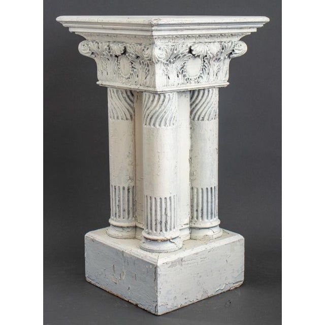 Neoclassical Style White Painted Wood Pedestal or Plant Stand, with a Corinthian capital above four carved columns above a...