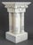 Neoclassical Style White Painted Wood Pedestal or Plant Stand, with a Corinthian capital above four carved columns above a...