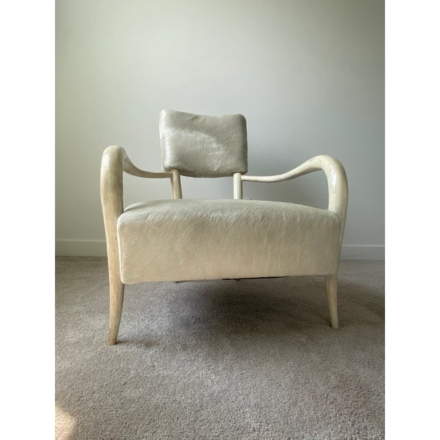 A striking pair of Bernhardt Interiors Elka accent chairs featuring a sculptural silhouette, luxurious ivory-white hair-...