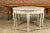 A pair of Swedish Rococo style painted wood demi lune console tables from the 19th century with cabriole legs. This pair...