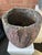 Vintage crucible, repurposed as unique planter or pot, carries the marks of their industrial past while offering a...