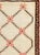 This Mid-20th Century Turkish Anatolian rug presents a simple, rhythmic lattice design across a warm ivory field. A...