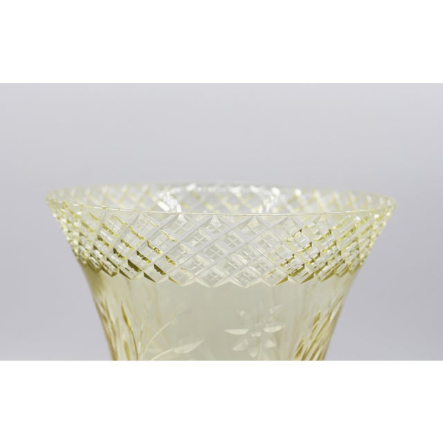 Hand cut vaseline glass vase, circa 1890-1910, likely American. Corset form with widely flared rim. Diamond cut work band...