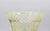 Hand cut vaseline glass vase, circa 1890-1910, likely American. Corset form with widely flared rim. Diamond cut work band...