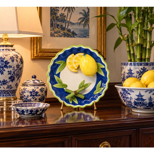 A 8-inch, hand-painted ceramic plate, with figurative lemon fruit and bamboo pieces. Good condition.