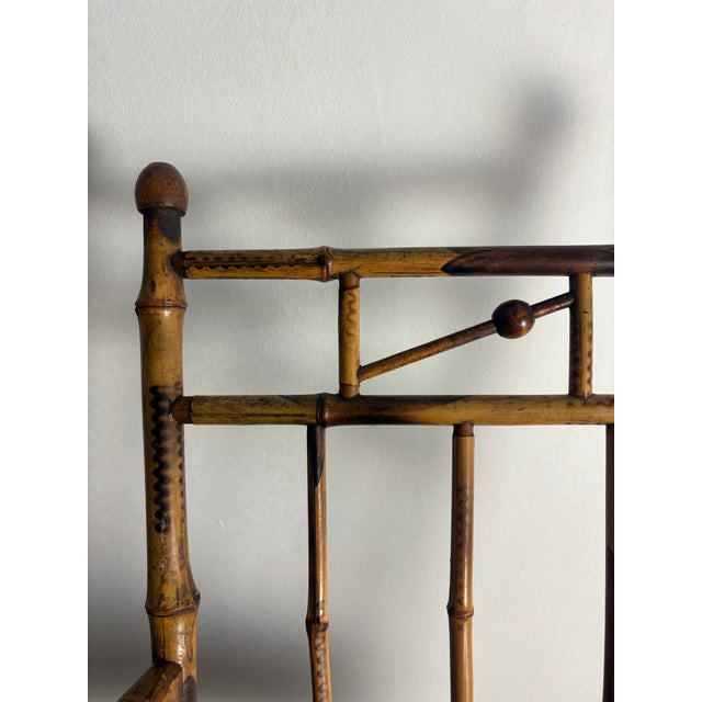 Charming child's rocking chair crafted from bamboo and wood with hand-burned (pyrography) decorative detailing throughout...