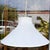 Vintage swag pendant lamp characterized by a flared, tightly pleated off-white fabric cone shade suspended from an...