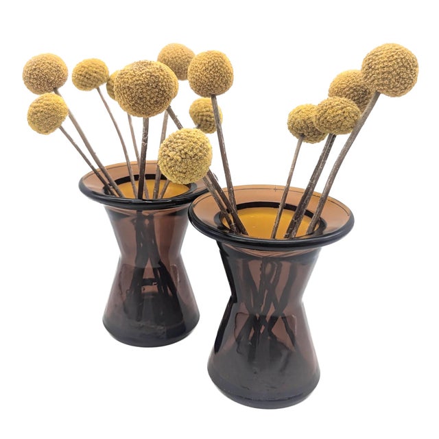 Offered are two amber-colored molded glass candle holders designed by Jens H Quistgaard and made in Finland for Dansk in...