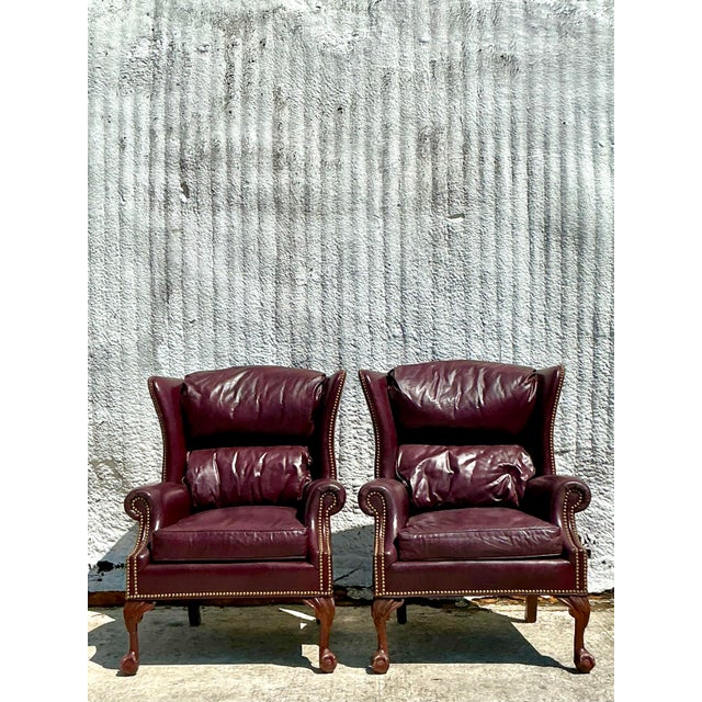 Make a bold and timeless statement with this pair of Vintage Regency-style wingback chairs, richly upholstered in deep...