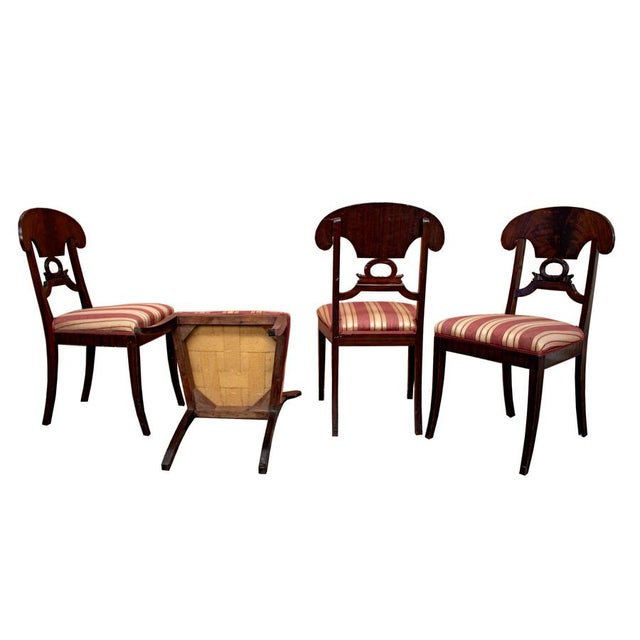 Set of four European neoclassical-style chairs with the typical "gondola" shape of the backrest, made in the 19th century,...