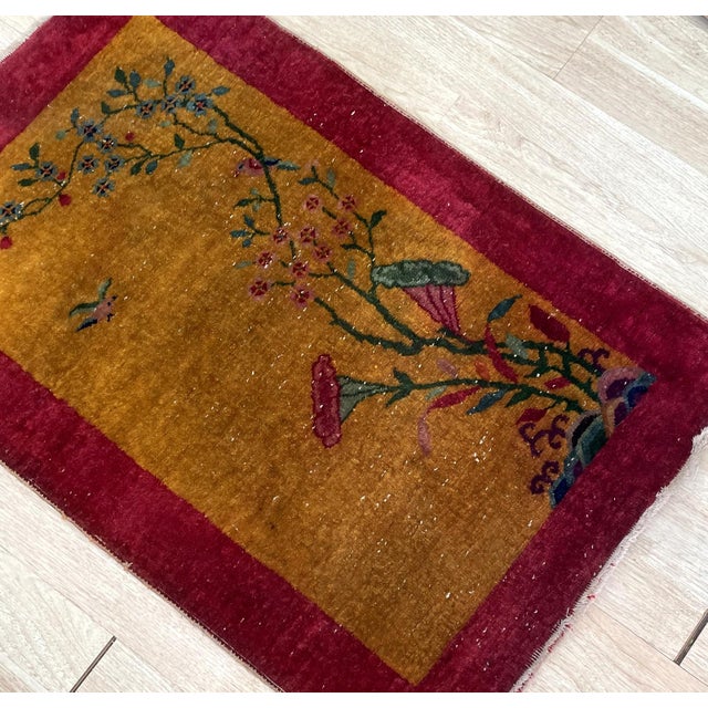 A vibrant example of early 20th-century textile art, this antique Chinese Art Deco rug features a glowing golden-yellow...
