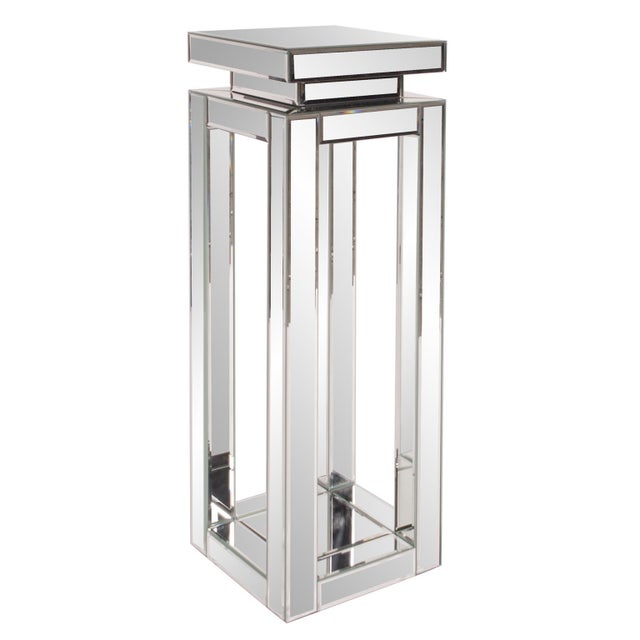This mirrored pedestal table features a mirrored open frame body with mirrored top surface. Each mirrored panel has a...