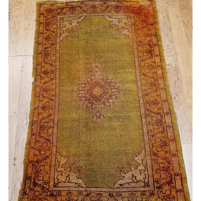An exquisite antique Turkish Oushak area rug from the late 19th century, showcasing the masterful artistry of the...
