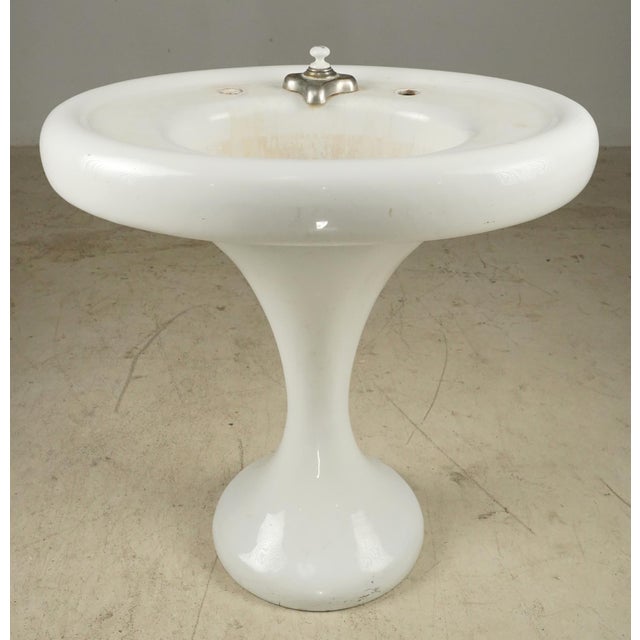 Vintage Art Deco porcelain enameled cast iron pedestal sink with a minimalist curved base. This piece was originally...
